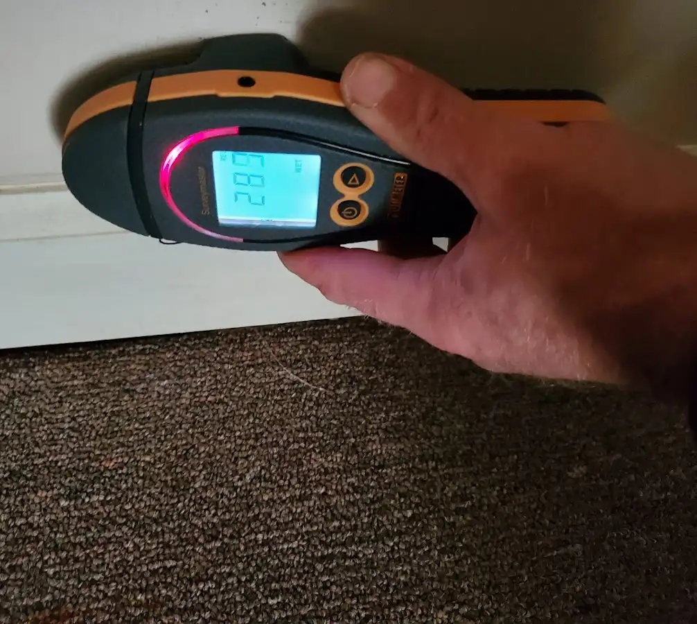Moisture detection at baseboard during Storm Damage Restoration in Volney